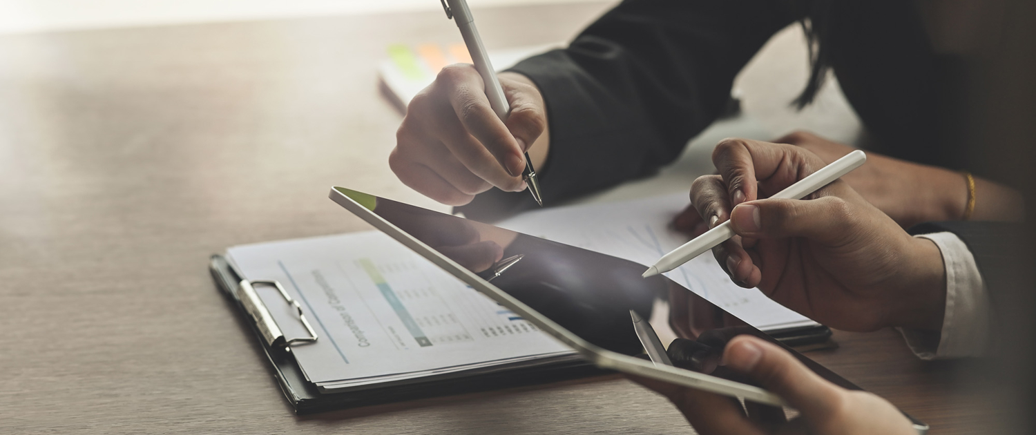 Side View Of Two Businesspeople On Tablet
