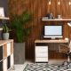 Comfortable Workplace With Computer Near Wooden Wall In Stylish Room Interior
