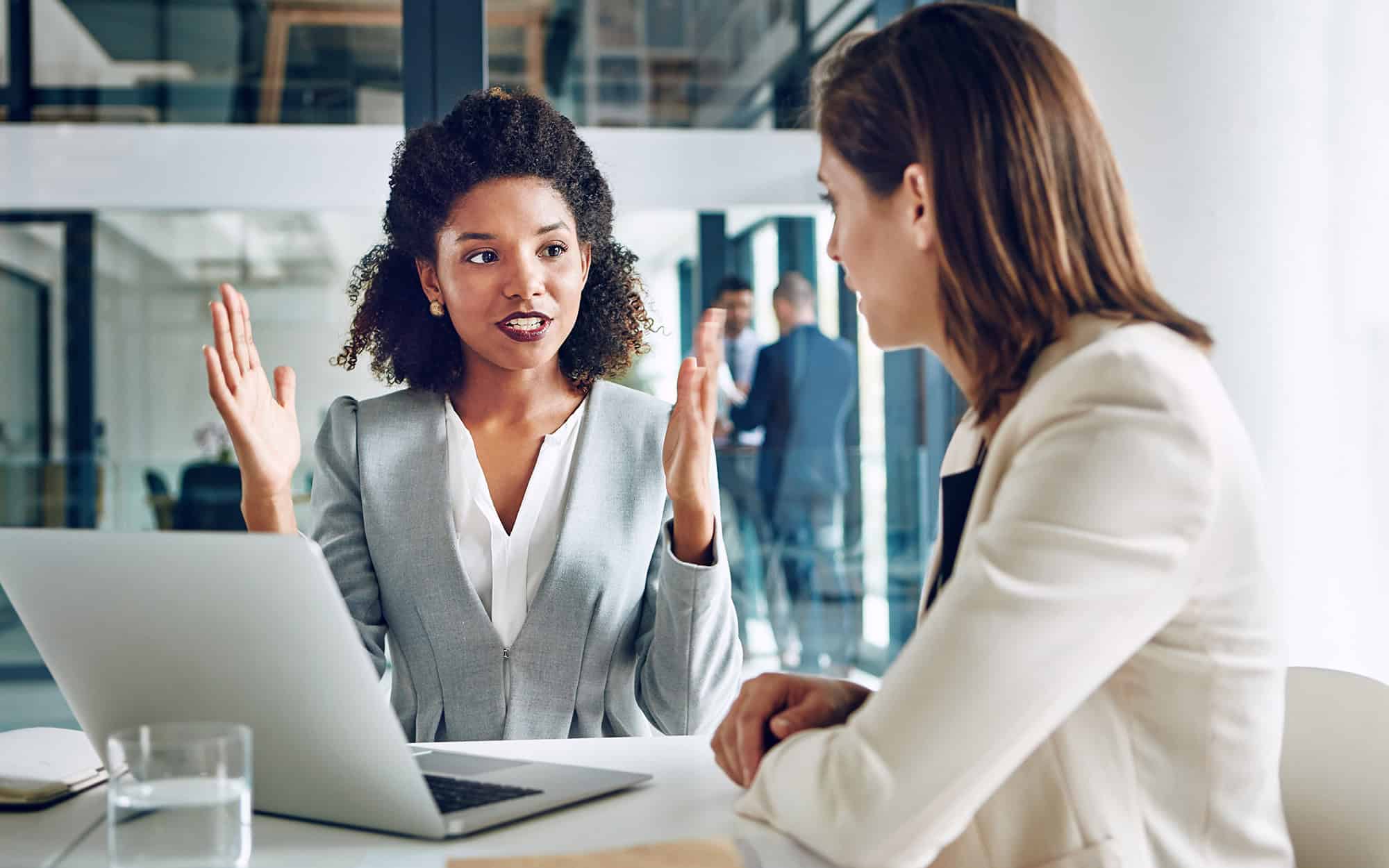 Laptop, Talking And Business Women In Office For Discussion