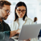 Design Professionals Using A Laptop Together In An Office